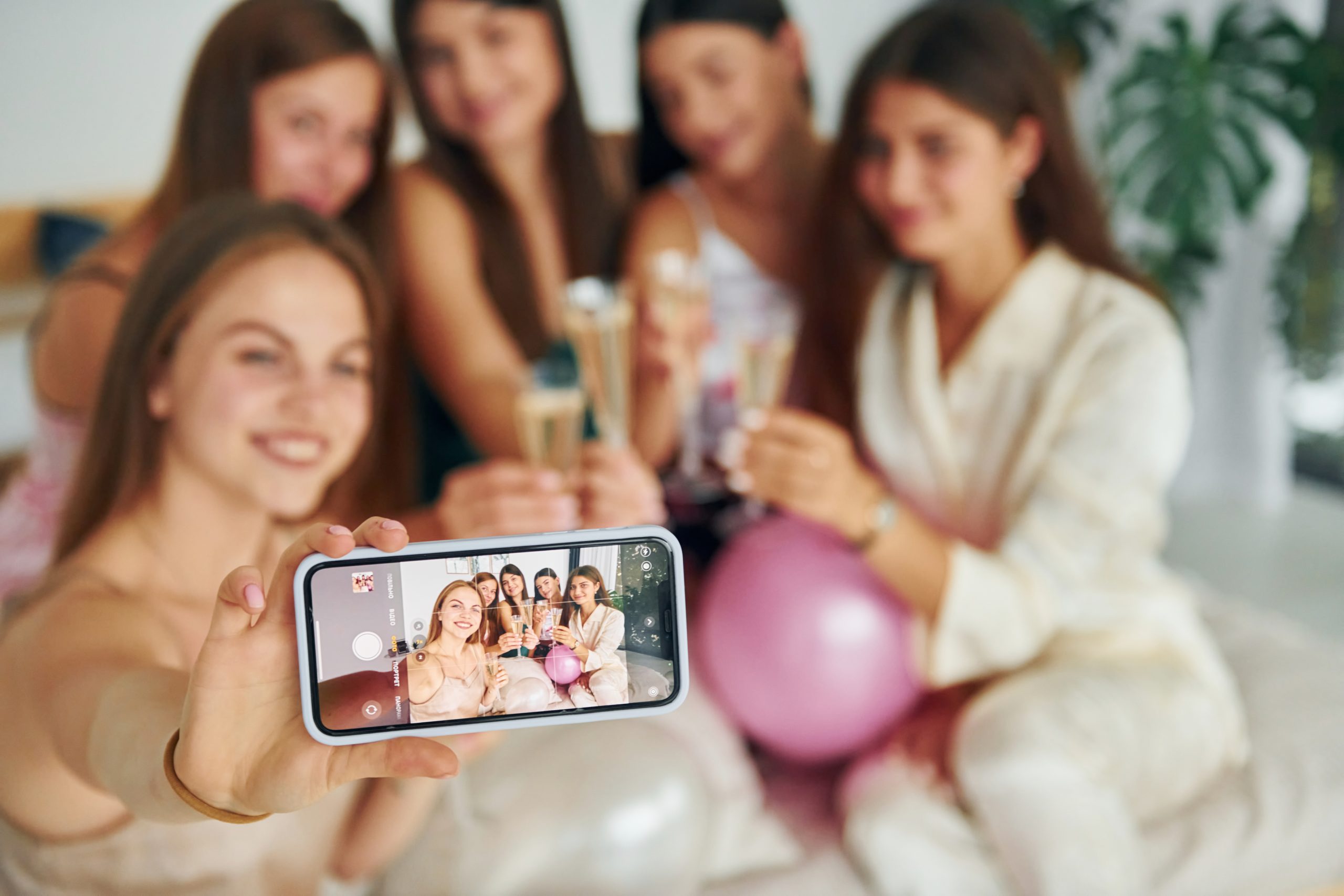 Holding glasses with drink. Group of happy women that is at a bachelorette party Holding glasses with drink. Group of happy women that is at a bachelorette party.